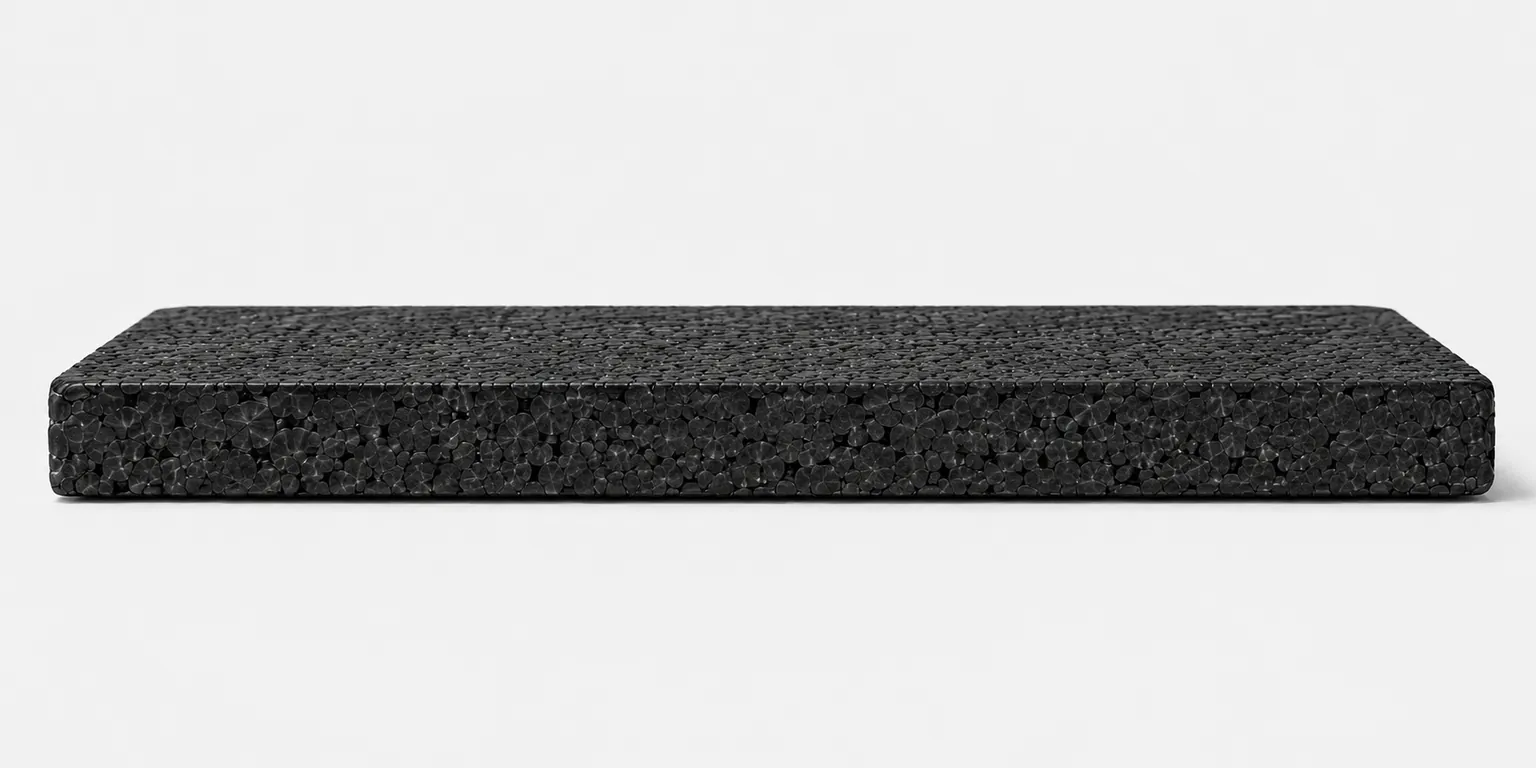 Cross-section of a molded EPP part showing fused black closed-cell polypropylene beads